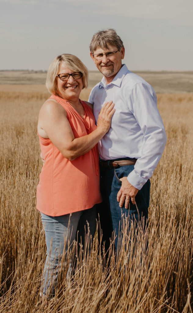 Phil and Janice Bamesberger in their field of harvested wheat